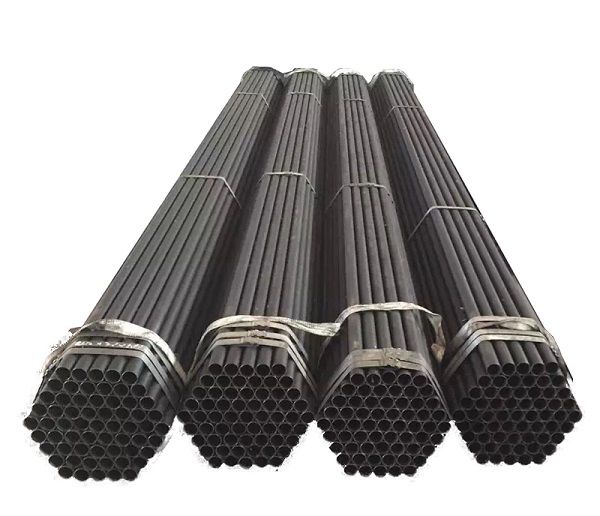 Close-up detail of ASTM A53 ERW black iron welded steel pipe showing dark mill scale finish - uncoated carbon steel for gas lines and fire sprinklers